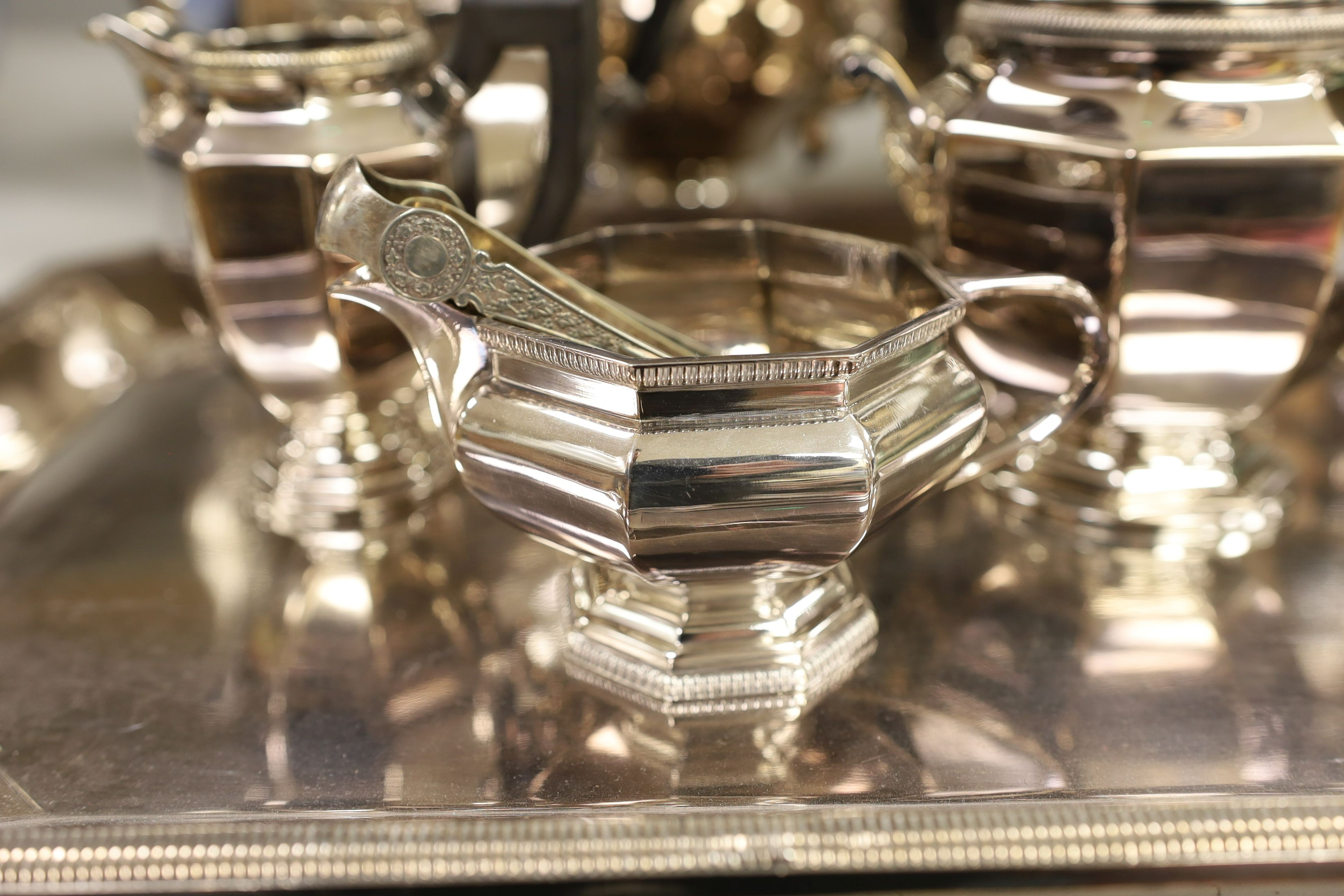 A French plated Cristofle tea set, together with other plated tea wares and a candelabrum